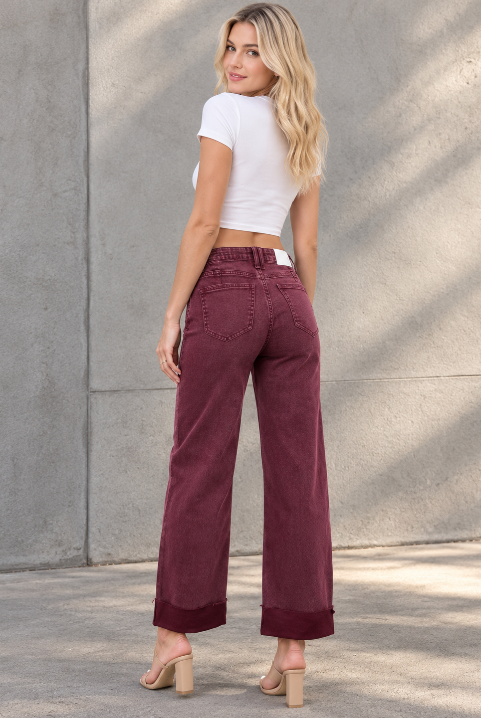 Blonde in Burgundy Denim Against Concrete.png