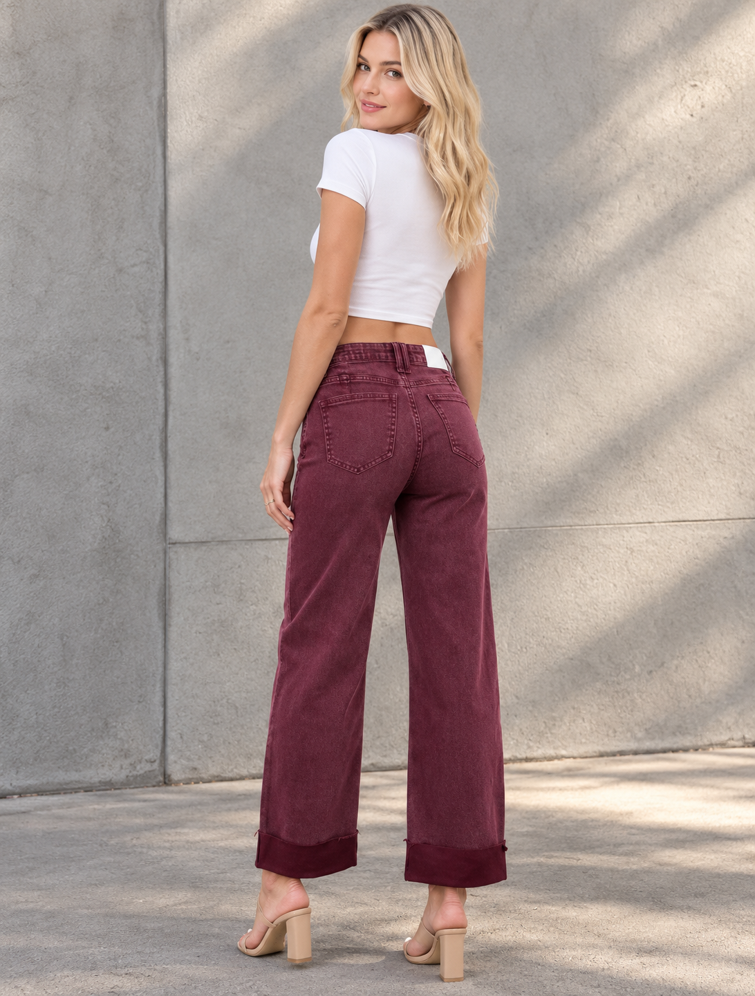 Blonde in Burgundy Denim Against Concrete.png