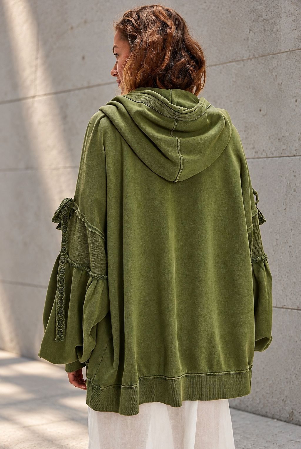 Olive Hoodie Against Concrete.png