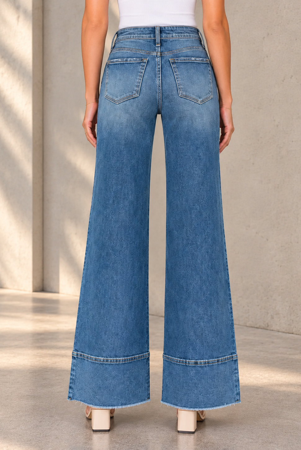 Wide-Leg Jeans Against Stone Wall.png