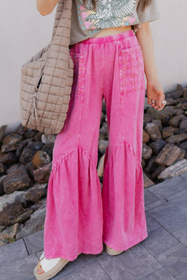 Pink flare leg pants with a quilted bag