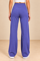 Back View in Purple Wide-Leg Pants.png