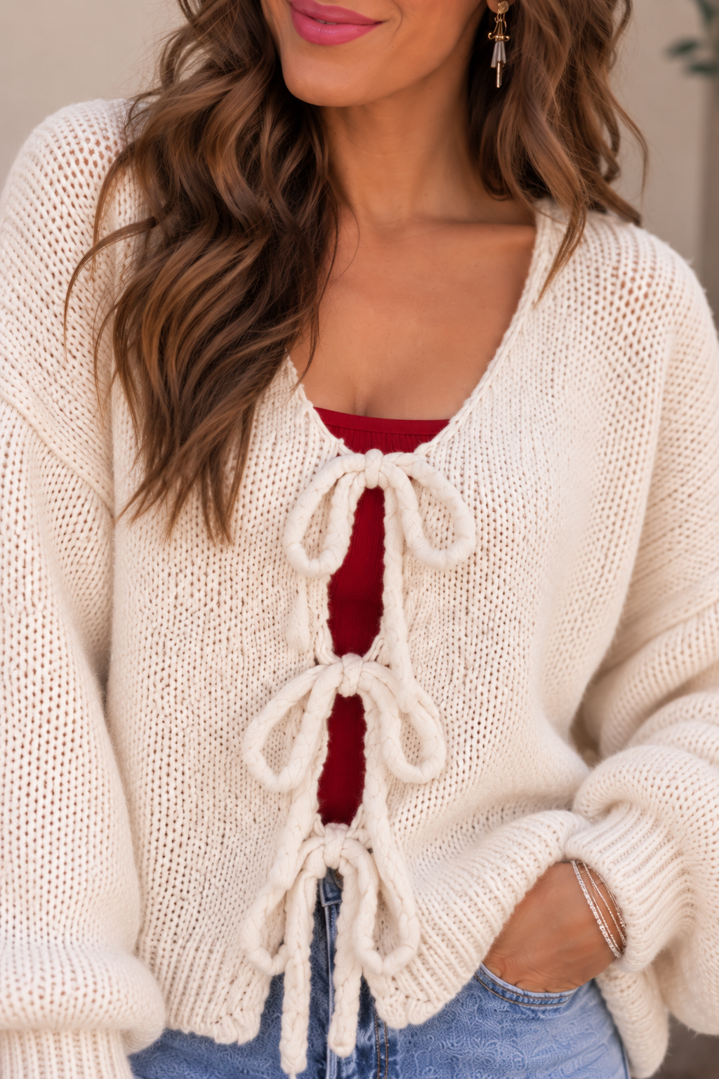 Cozy Cream Cardigan with Red Accents.png