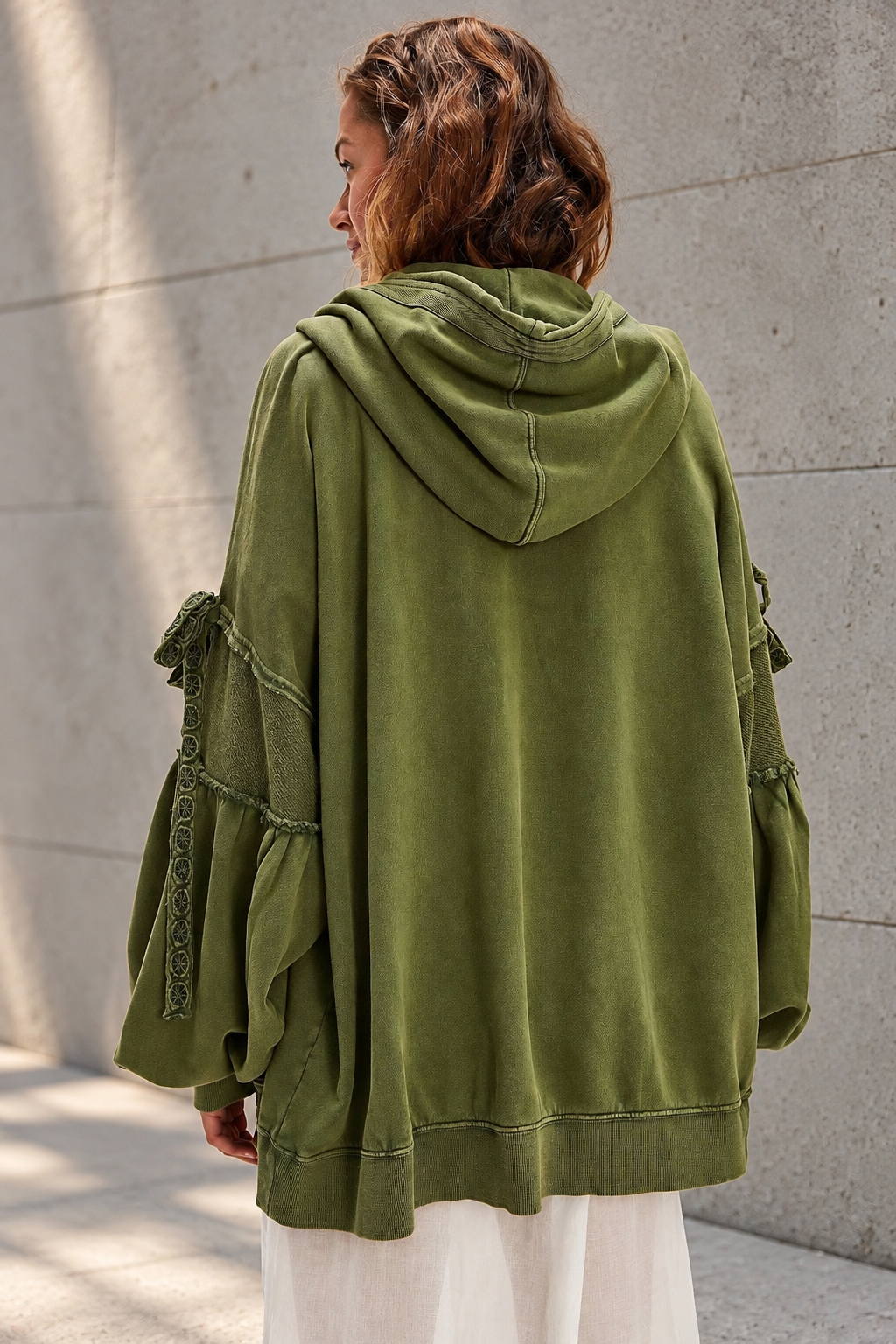 Olive Hoodie Against Concrete.png