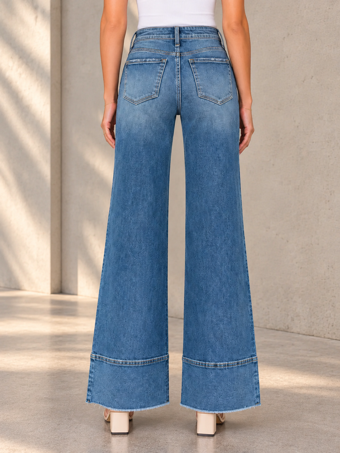 Wide-Leg Jeans Against Stone Wall.png