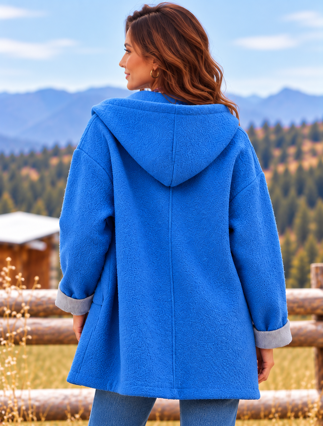 Woman in Blue Coat by Mountain Fence.png